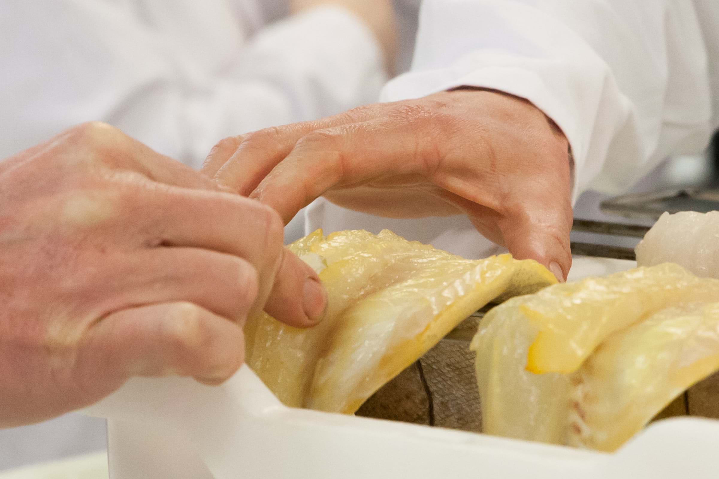 A close up on a smoked fillet being examined
