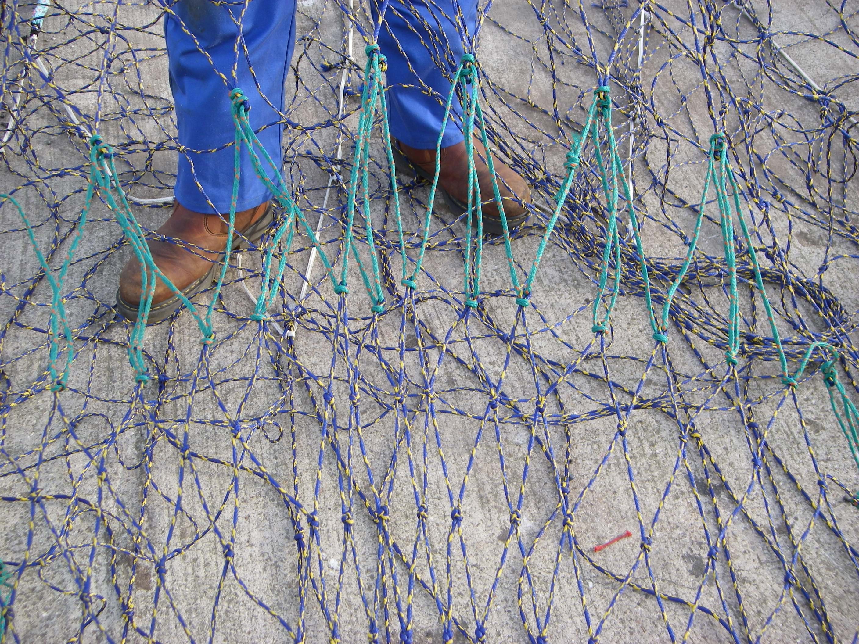 Netting being held up and tight to show diamond shaped mesh