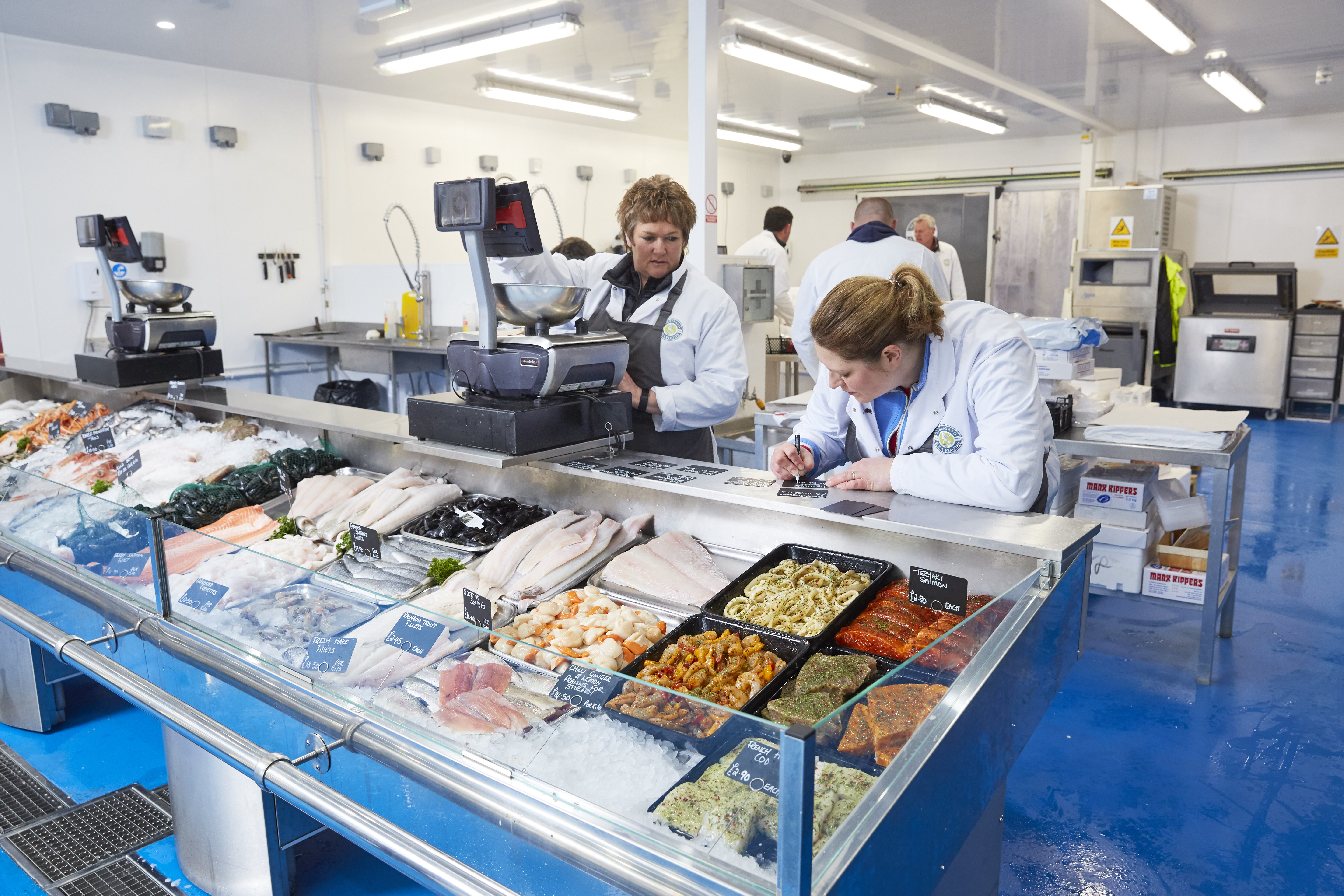 Photo of people working behind counter in a fishmongers