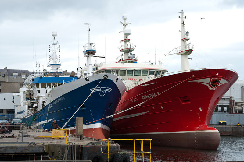 Two vessels tied up at harbour