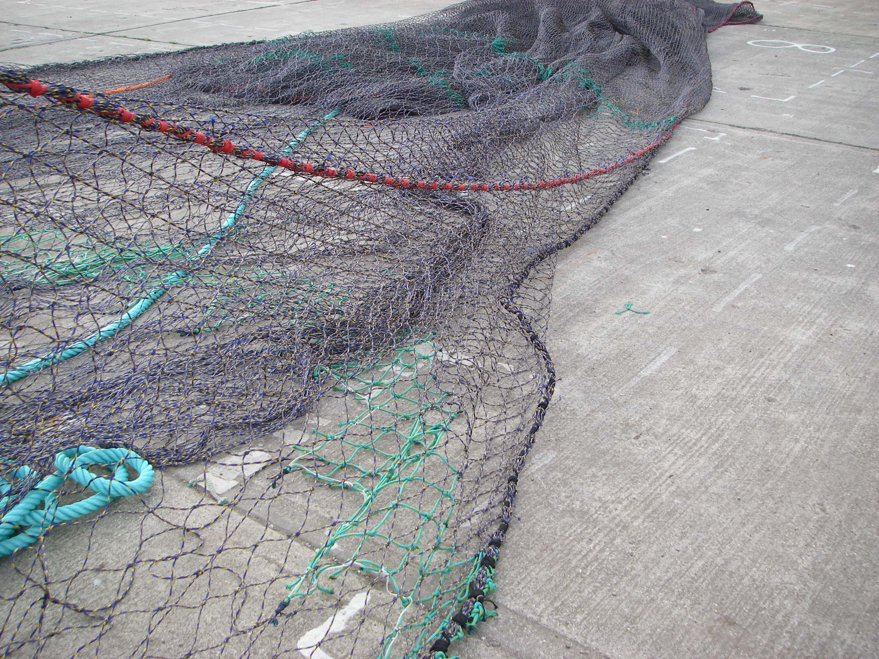 Netting held in mid-air to show the diamond mesh