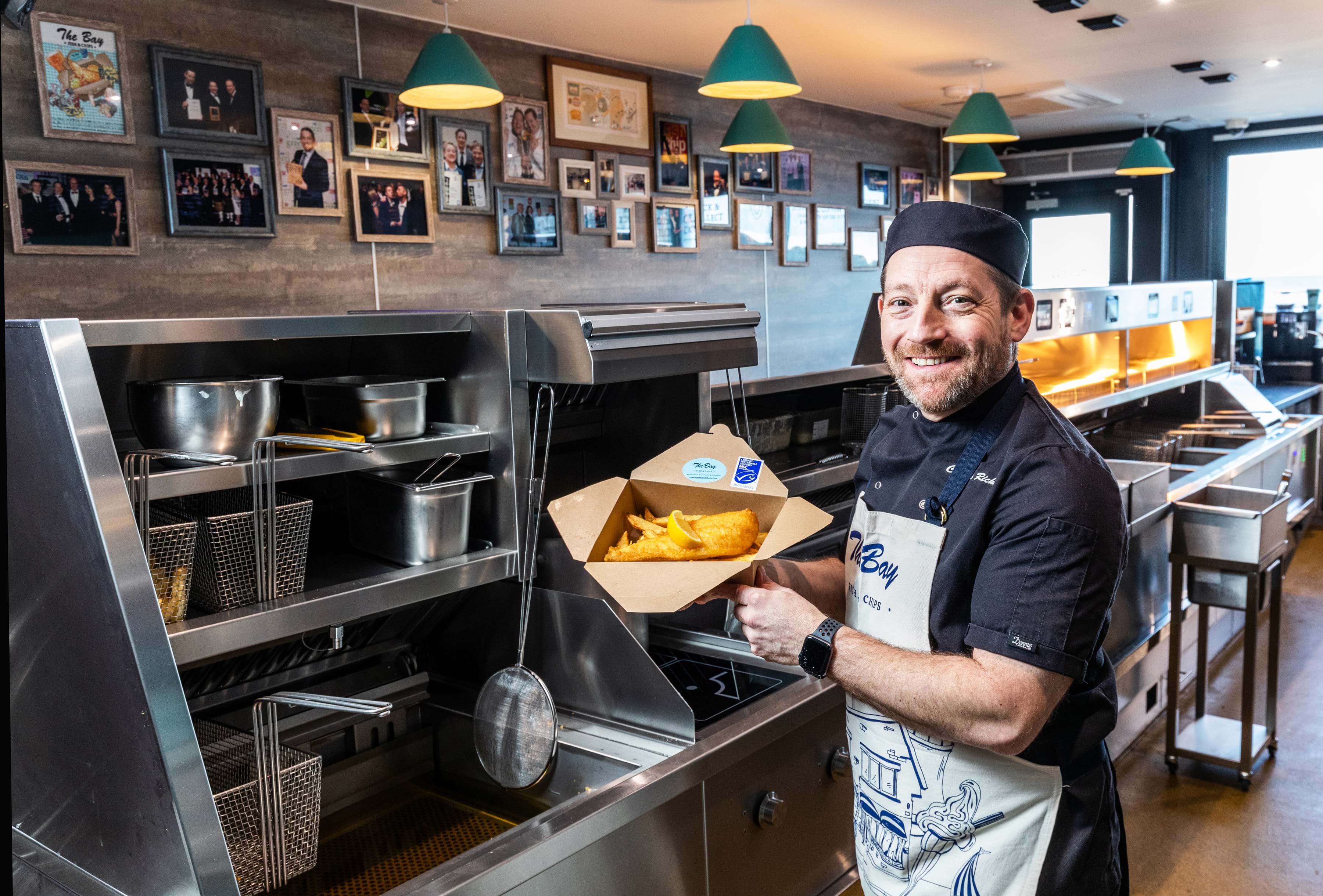 Photo of owner Calum Richardson inside the Bay fish and chip shop