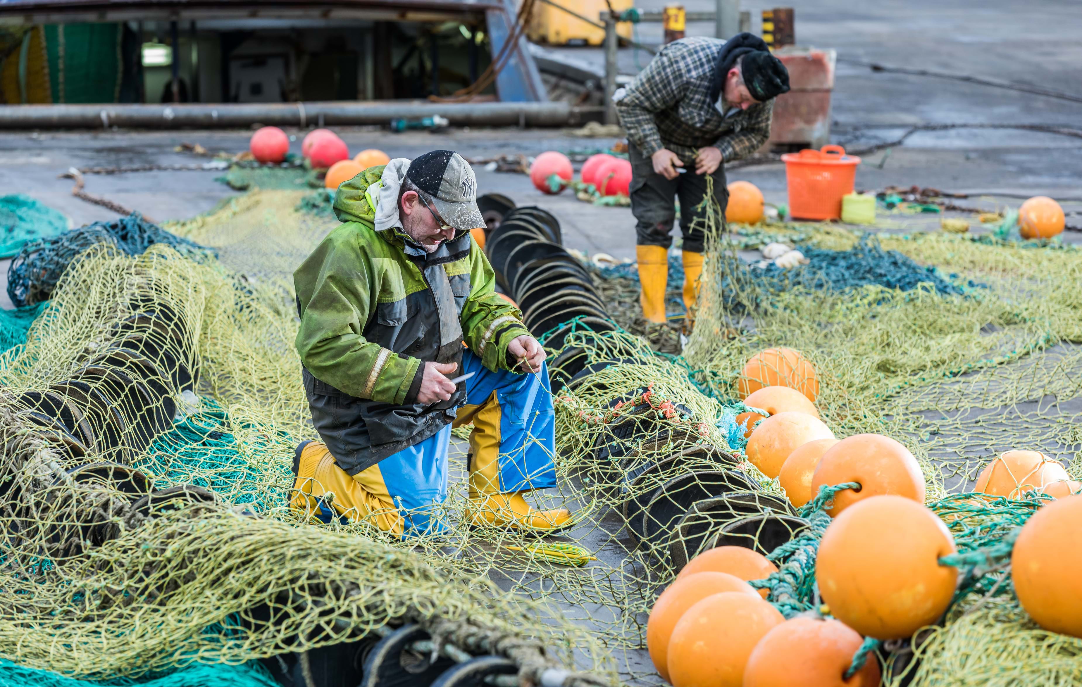 Fishermen mending nets.