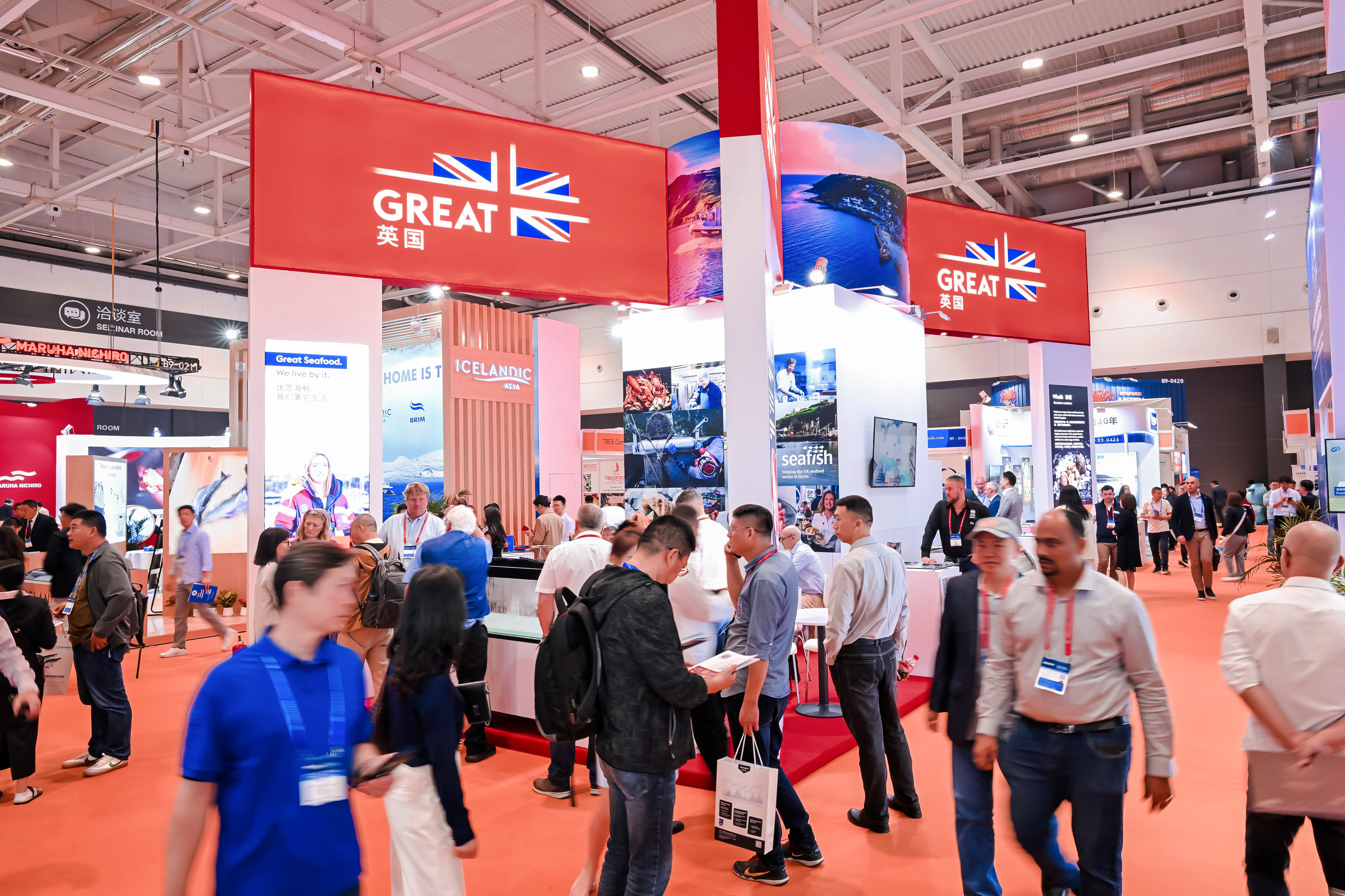 A general view of the Great Britain exhibit at the 2023 China seafood trade show with people walking by.