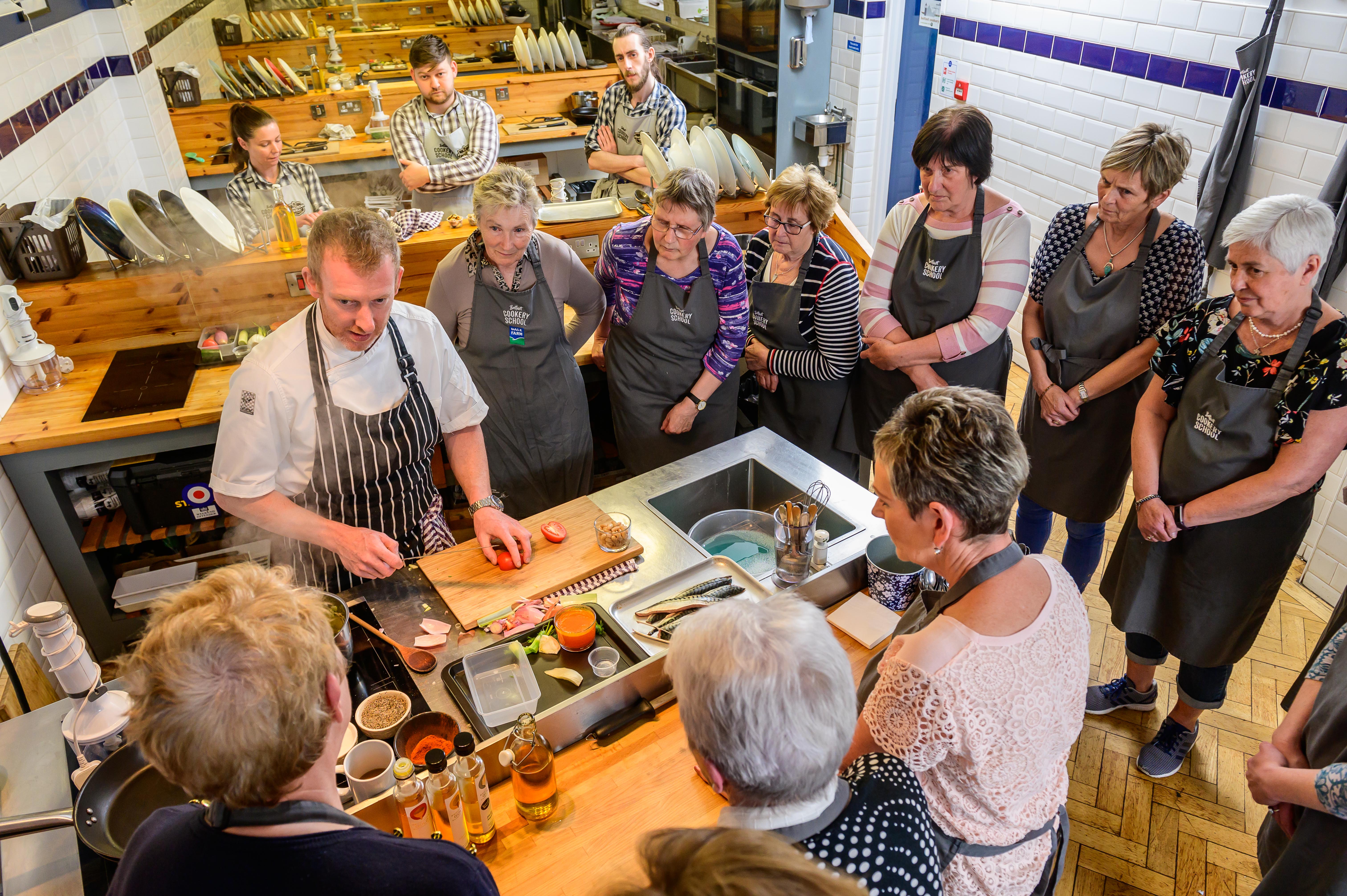 People in a kitchen learning about seafood at an event in Northern Ireland