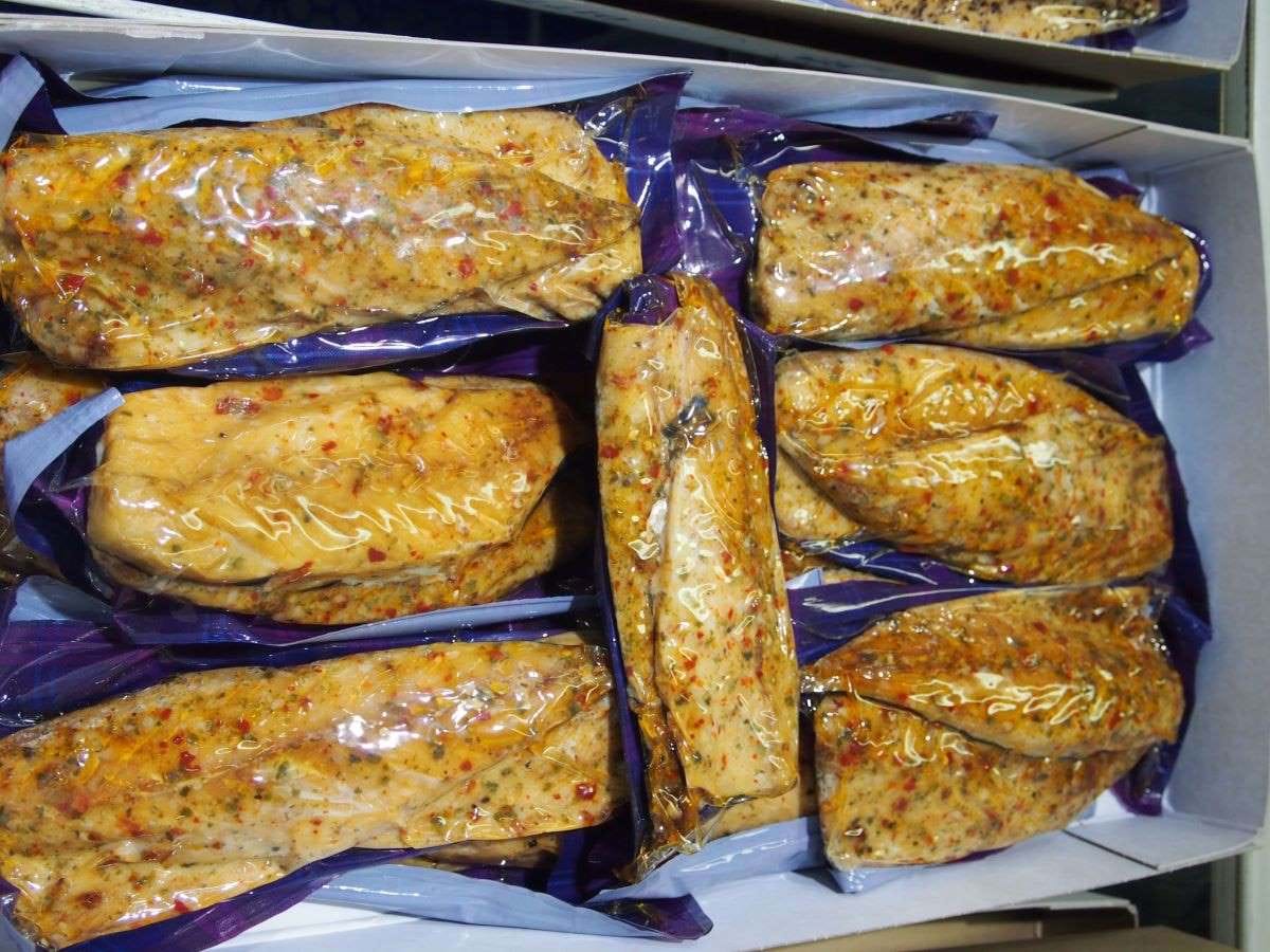Photo shows a box of fish fillets in individual vacuum packaging.